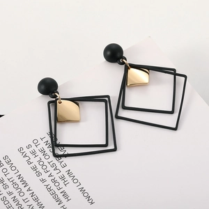 Minimalist black and gold geometric square drop earrings with a matte textured sphere