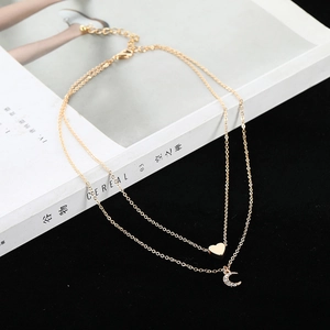 Chic layered gold necklace with heart and crescent moon pendants for modern women