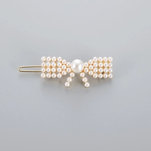 Elegant gold plated alloy hair clip with white imitation pearls in a bowknot shape design
