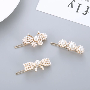 Three-piece gold alloy hair clip set with faux pearls in butterfly and bow designs