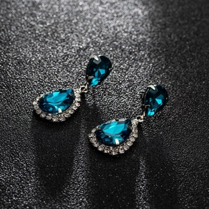 Elegant silver teardrop earrings with deep blue zircons and white rhinestone halo