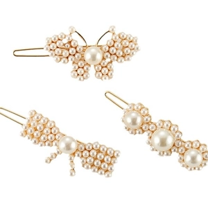 Three elegant gold alloy hair clips set with white pearls in butterfly and wave designs