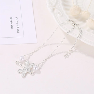 Elegant dragonfly anklet with white pearls and polished silver chain for beach jewelry styling