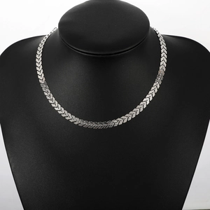 Minimalist silver chevron fishbone necklace on black bust display stand for women