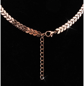 Detail of rose gold herringbone chain necklace with lobster clasp and extension link