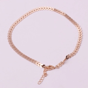 Detailed macro view of rose gold V-shaped geometric chain with lobster clasp closure