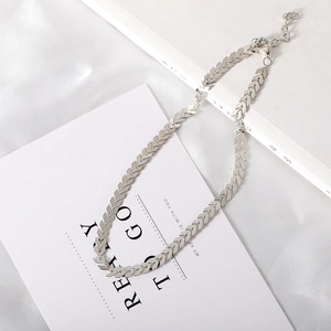 Close-up of silver V-shaped link chain with lobster clasp and adjustable extension chain