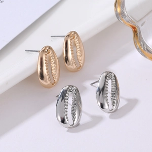 Detailed view of shell-shaped gold and silver alloy stud earrings with textured finish