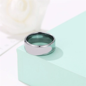 Polished wide band silver steel ring for men and women on a light green gift box
