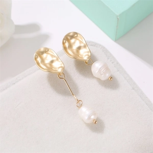 Elegant asymmetrical freshwater pearl earrings with irregular gold textured metal dangles