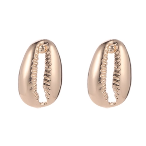 Macro view of gold shell earrings showing polished alloy texture and seashell design