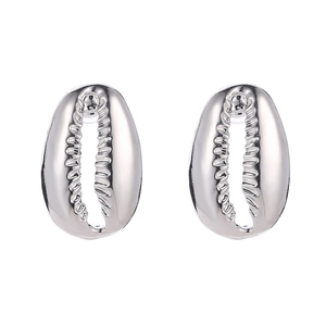 Macro shot of silver shell stud earrings with mirror polished finish and detailed texture
