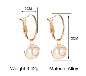Detailed view of gold alloy drop earrings with spiral wire wrapped faux pearl pendants