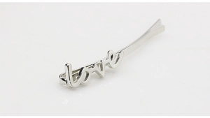 Close-up of polished silver alloy hair clip featuring a stylish cursive love letter design