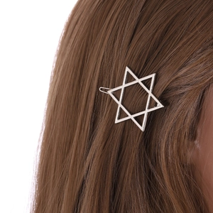 Minimalist silver star metal hair clip accessory for women shown on brown long hair