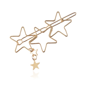 Detail of a gold star hair clip set with hollow pentagrams and a small solid star charm
