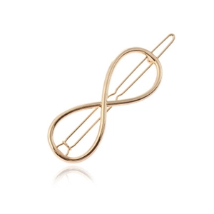Detail of a golden infinity symbol hair clip featuring a minimalist sleek metal finish