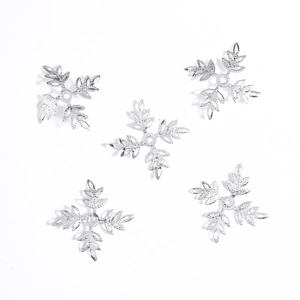 Set of five silver snowflake jewelry accessories for DIY hair pins on white background