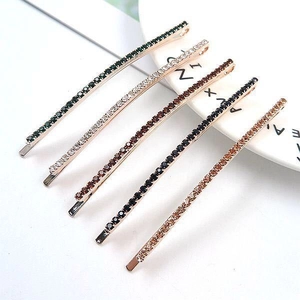Detailed close-up of a five-piece rhinestone hair clip set in assorted elegant colors