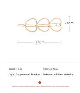 Macro detail of alloy gold heart hair clip with 7.5cm length and 6.5g weight info