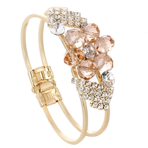 Detail of gold double-layer bracelet with champagne crystal plum flower and pavé rhinestones