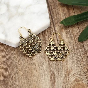 Vintage bohemian alloy hollow honeycomb earrings with 3D bee design in antique gold finish