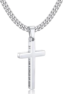 Macro view of side engraving on stainless steel cross pendant with a Cuban link chain