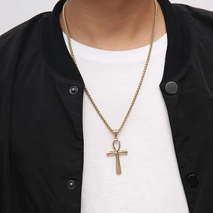 Golden Ankh cross pendant necklace with wheat chain shown on a male model outfit