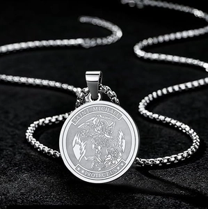 Detailed macro view of Saint Michael medallion necklace with polished silver steel finish