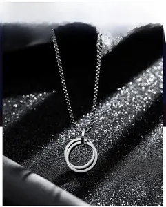 Detailed macro view of interlocking double ring pendant on a fine silver square chain