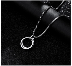 Close-up of interlocking double ring pendant on box chain with polished finish
