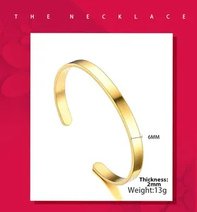 Detail of 6mm wide gold C-shaped stainless steel bangle with brushed metal texture