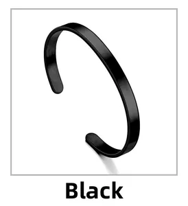 Close-up of minimalist black C-shaped stainless steel bracelet with mirror finish