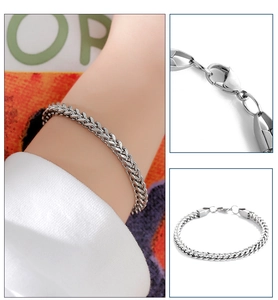 Detail view of silver titanium wheat chain bracelet with lobster clasp and model lifestyle shot