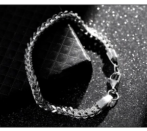 Detailed view of polished wheat chain link design with large lobster clasp for men