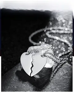 Macro shot of mirror-polished puzzle heart pendants with elegant bokeh background