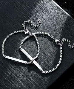 Detailed macro view of silver box chain bracelets with engravable rectangular metal bars