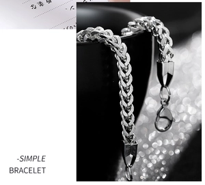 Detail of silver titanium steel chain bracelet with lobster clasp and woven wheat pattern