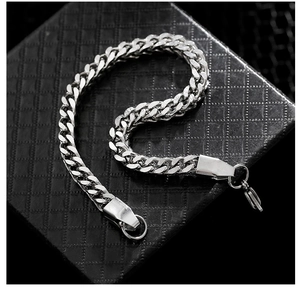 Detailed macro shot of silver titanium steel cuban chain bracelet on premium black jewelry box