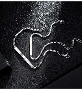 Detailed close-up of polished silver titanium steel bar bracelets on star-black background
