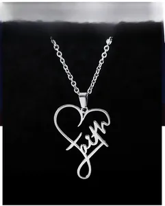Macro shot of silver heart pendant with Faith lettering and minimalist cross chain