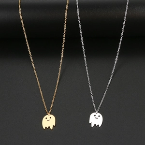 Detail view of gold and silver ghost pendant necklaces with cute cut-out faces on black