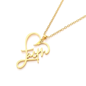 Macro shot of gold faith pendant showing heart design and polished stainless steel finish