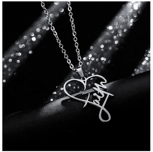 Detailed close-up of a silver heart pendant featuring the word faith on a sleek chain