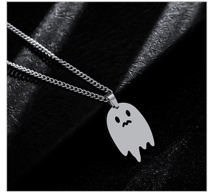 Close-up of a silver ghost pendant necklace for Halloween with detailed spooky facial features