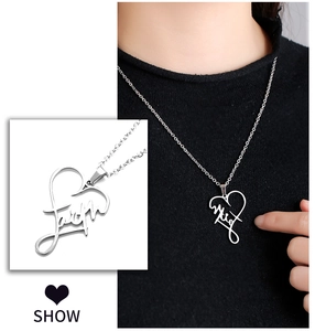 Detail of silver heart-shaped pendant necklace featuring faith engraving and fine chain
