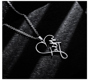 Macro detail of silver heart pendant featuring delicate faith engraving on O-chain