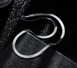 Detailed view of silver flat snake chain necklace with smooth metallic scale texture