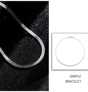 Macro view of polished silver herringbone snake chain bracelet with lobster clasp