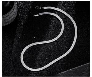 Detailed close-up of a silver flat snake bone chain necklace with a metallic mirror finish